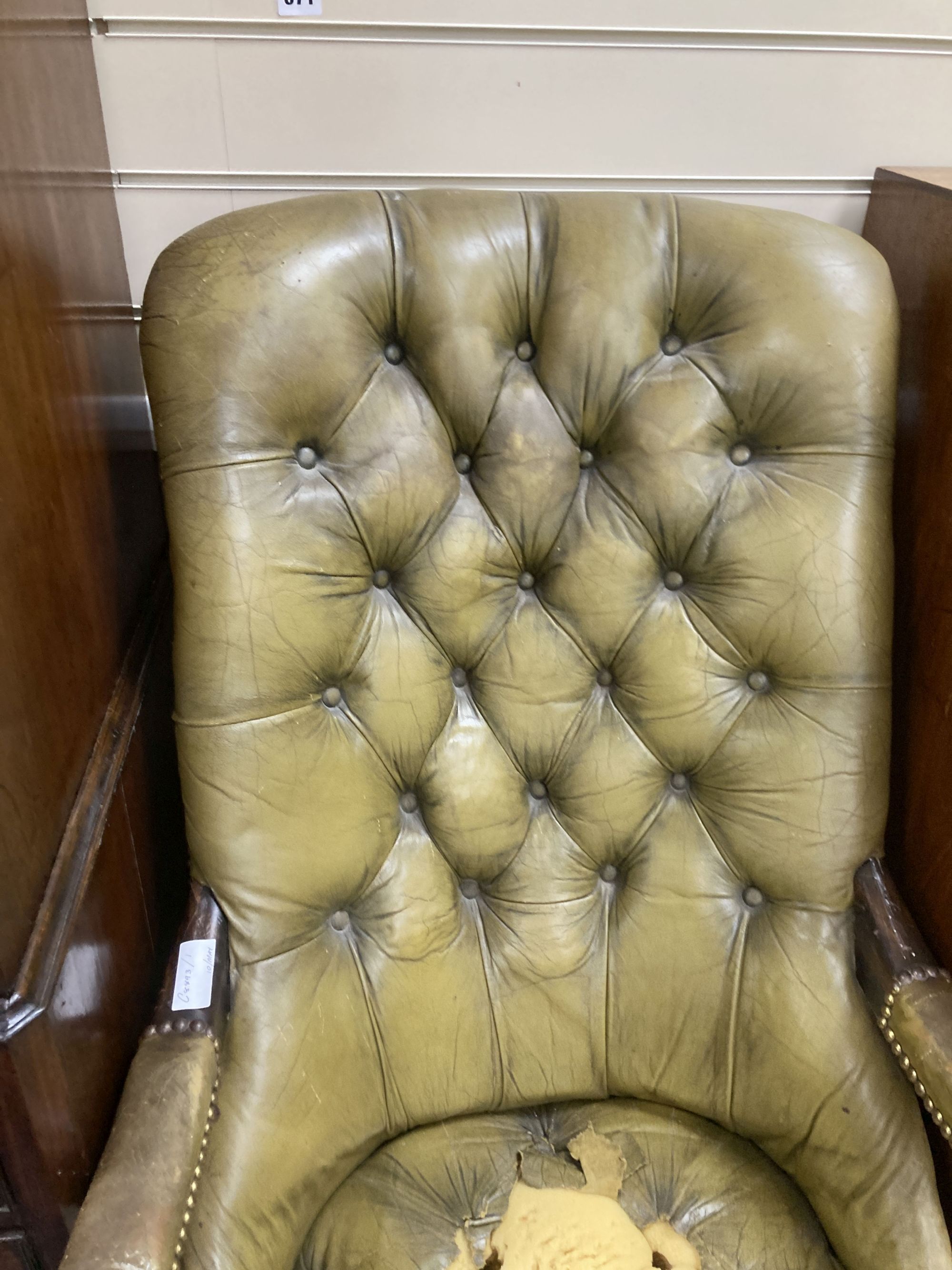 An early Victorian mahogany library armchair, upholstered in pale green leather, width 59cm, depth 84cm, height 104cm